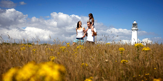 commercial image of a family walking in the meadows